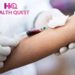 Blood sample collection procedure at Health Quest Imaging & Diagnostics, showing a healthcare professional drawing blood from a patient's arm for laboratory testing.
