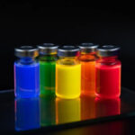 Five colorful water-soluble quantum dot solutions in laboratory vials for nanotechnology, fluorescence imaging, and biomedical research.