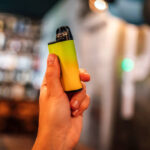 Disposable vape cigarette in woman hand