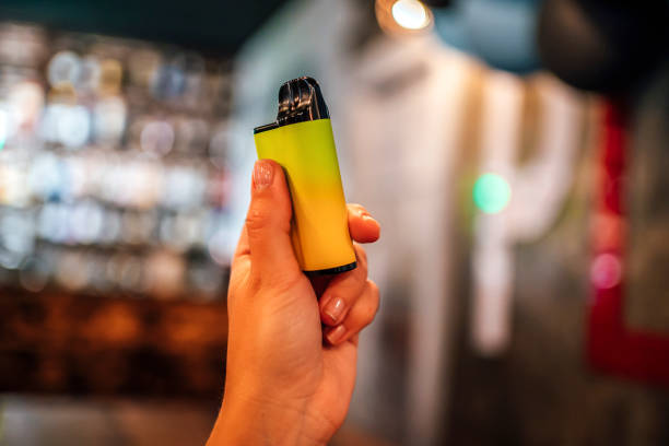 Disposable vape cigarette in woman hand