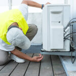 Technician Performing Maintenance On An Outdoor Air Conditioning Unit