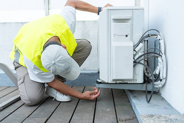 Technician Performing Maintenance On An Outdoor Air Conditioning Unit
