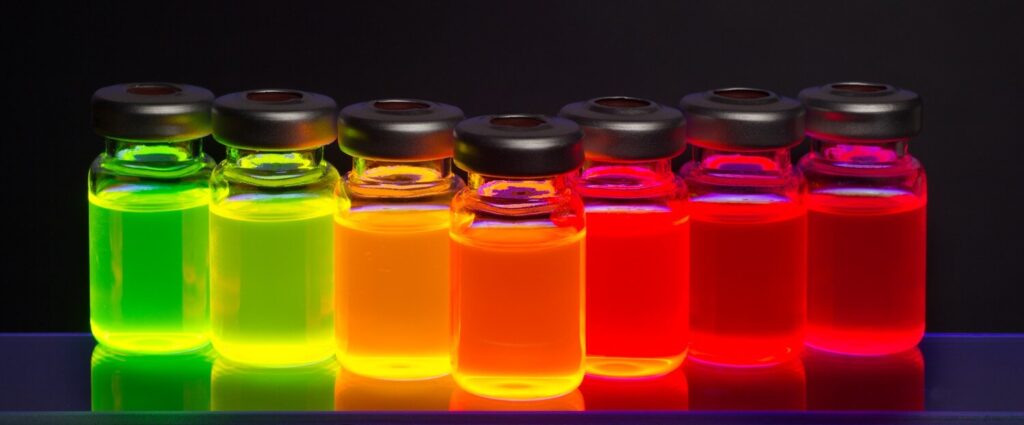 Vials containing brightly colored fluorescent quantum dots and nanoparticles for biomedical research and nanotechnology applications