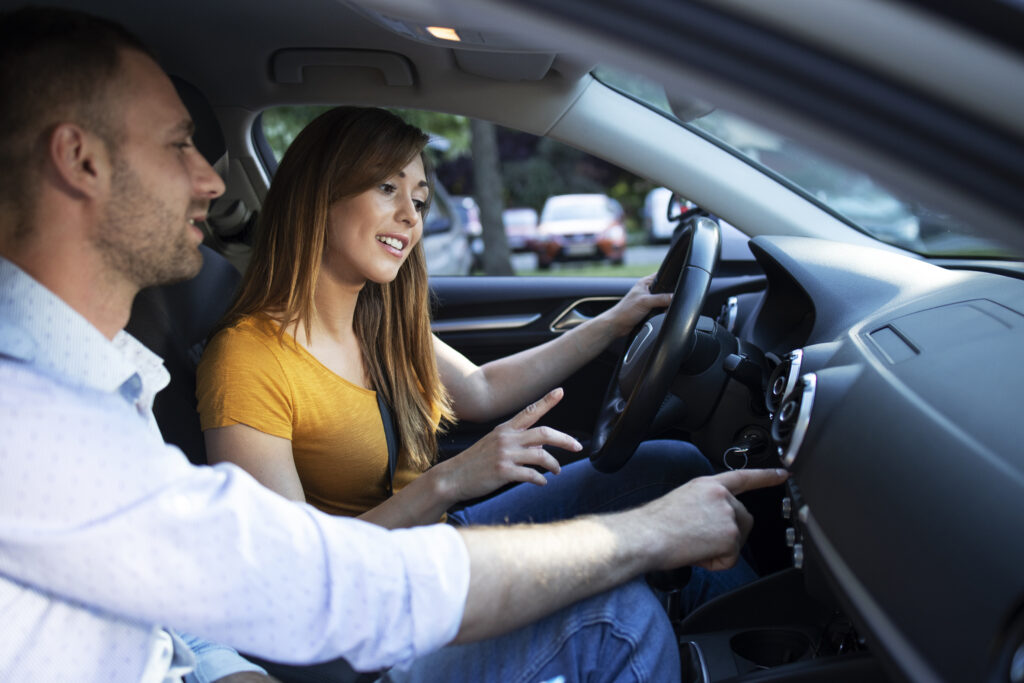 driving-instructor-showing-vehicle-dashboard-buttons-student-taking-driving-lessons-1024x683.jpg