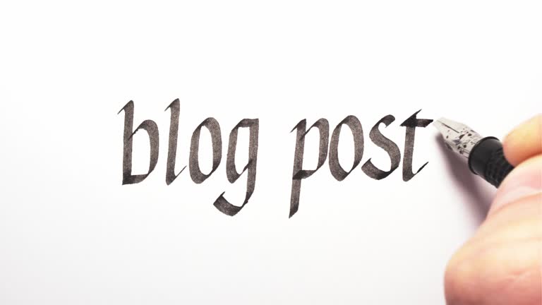 Blog post being written by hand. Calligraphy closeup.