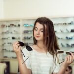 imgi_2_young-woman-shopping-holding-two-pairs-stylish-sunglasses_176420-3473