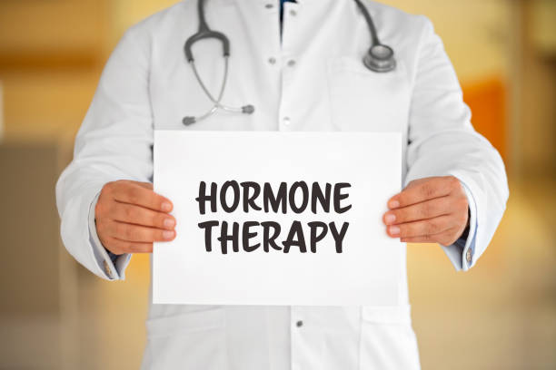 Doctor holding a white paper, Hormone Theraphy written on paper.
