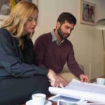 interior-designer-client-studying-blueprint_11zon