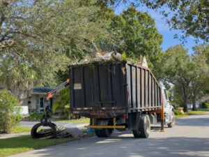 Bulk truck picking up trash in a community street, Plantation, Florida, USA