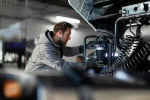 Professional truck service mechanic working.